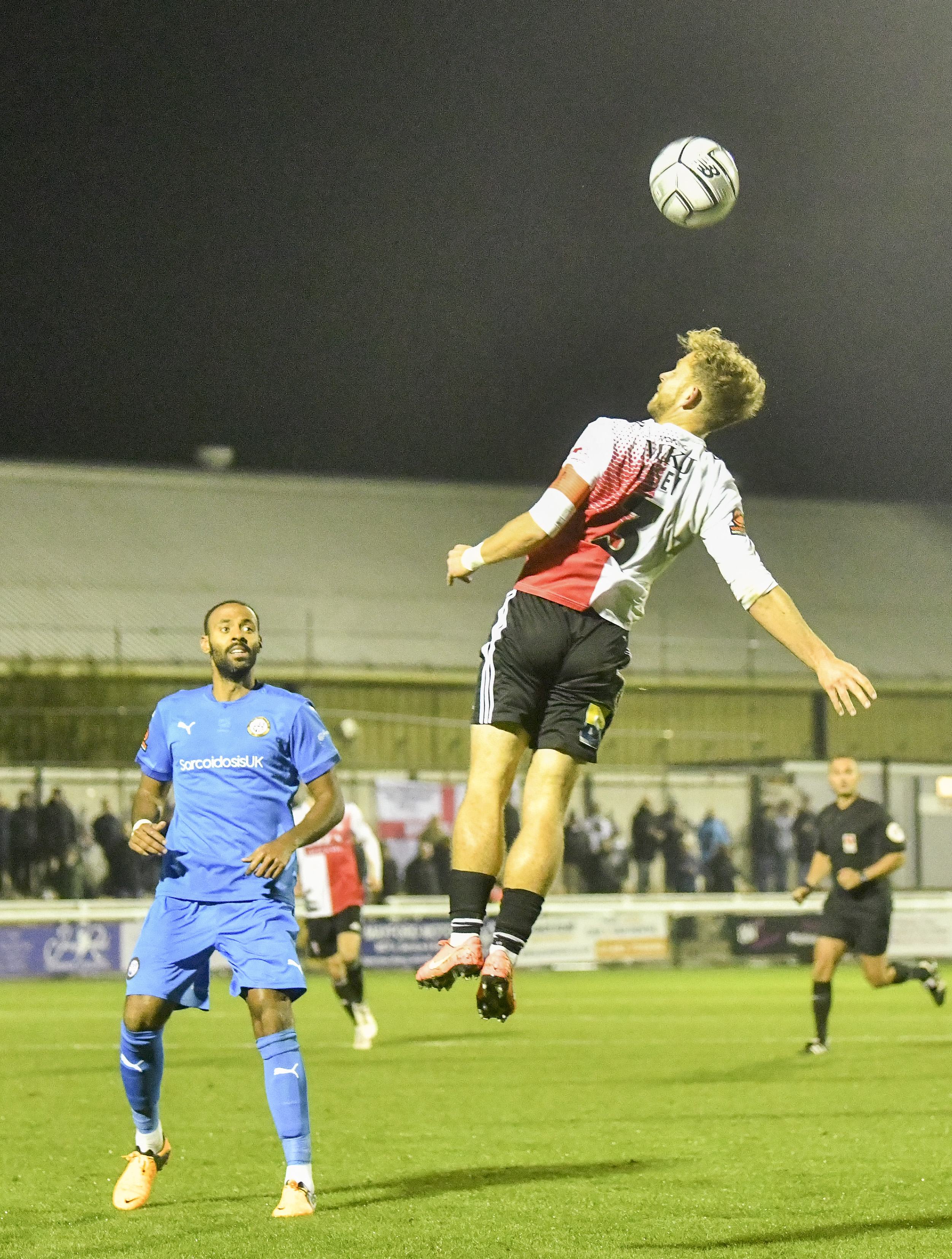 Woking’s captain rises to meet the ball